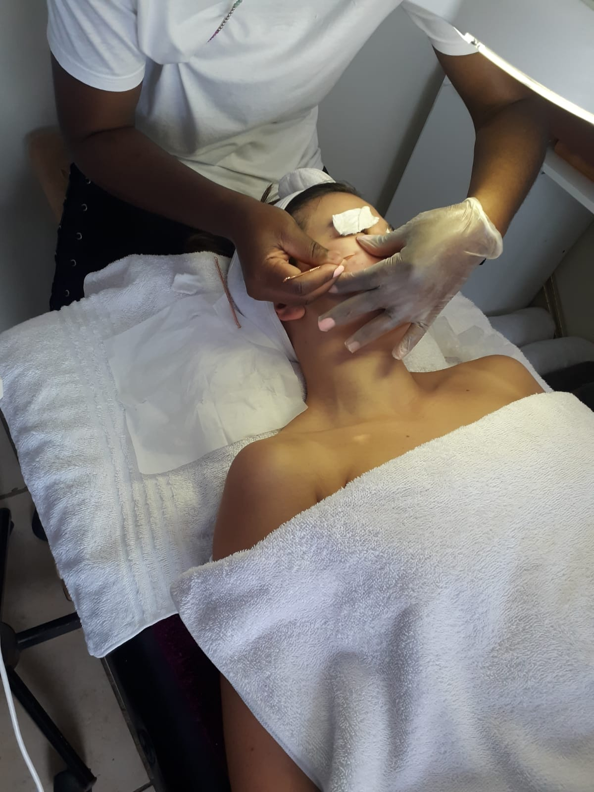 Facial extraction treatment under the magnifying lamp at Beauty by BM
