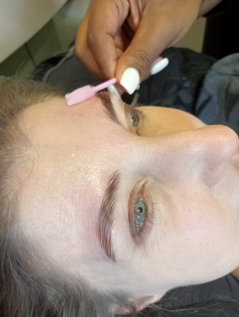 Brow lamination brushing and shaping in progress