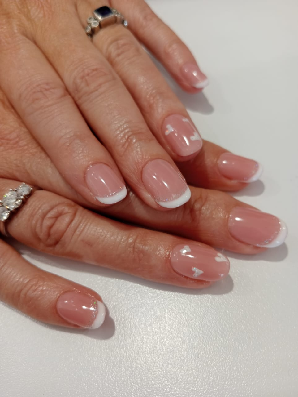 Classic French gelish manicure with delicate bow accent