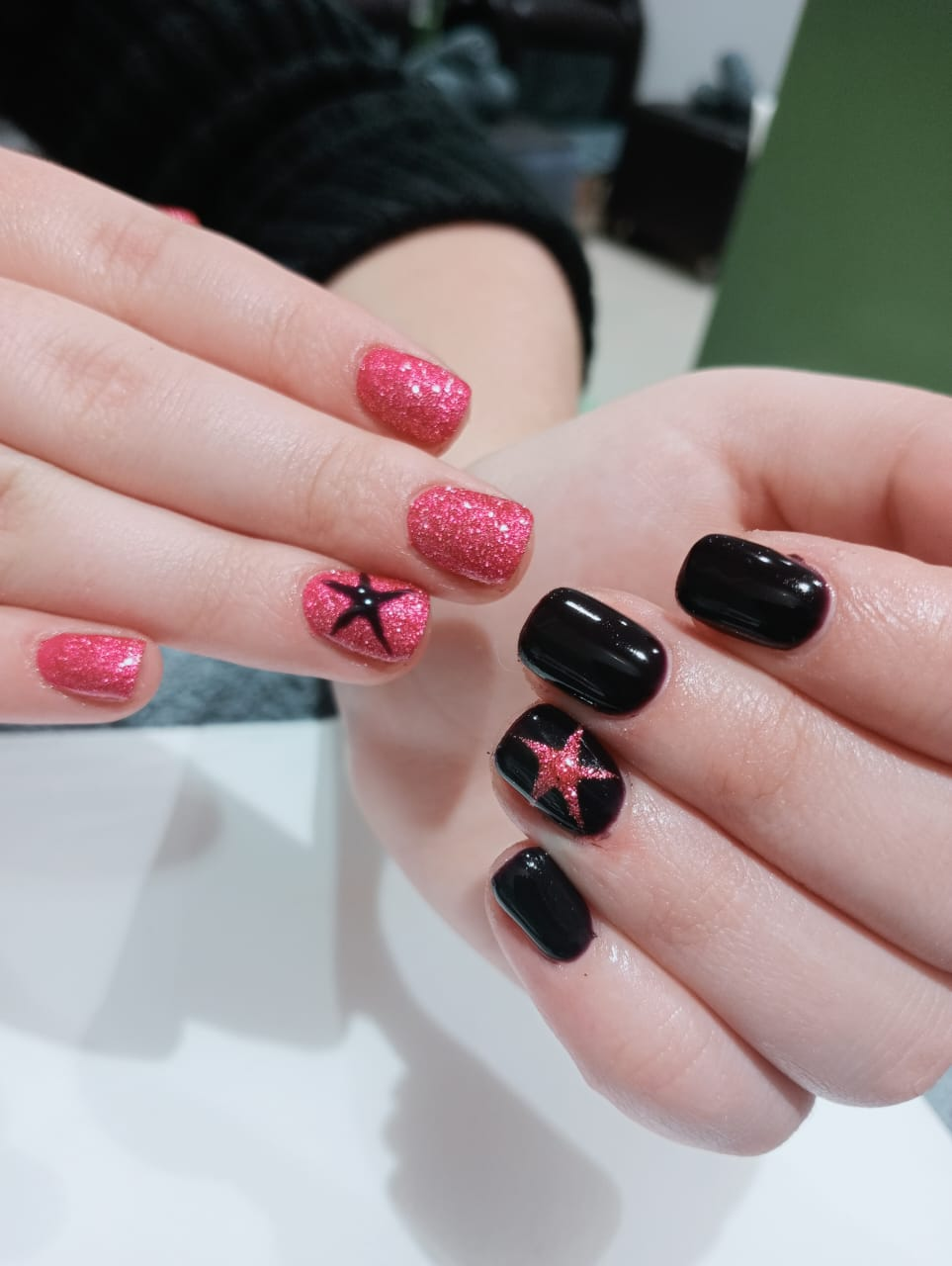 Pink glitter and black hard gel manicure with star accent art