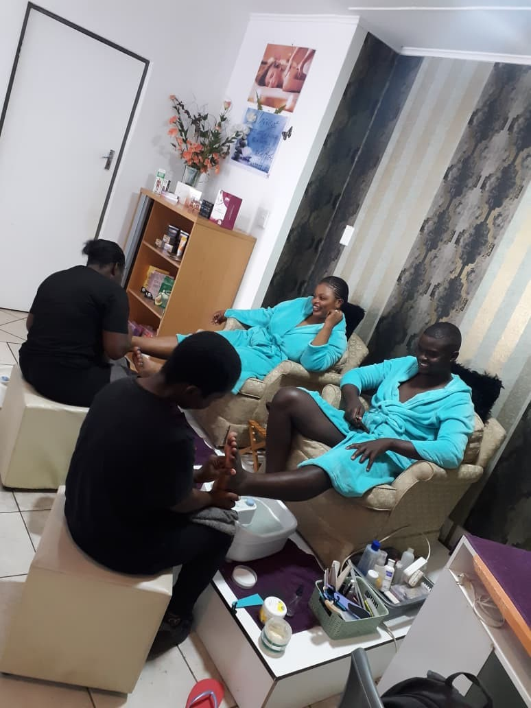 Guests in robes enjoying a couples pedicure experience